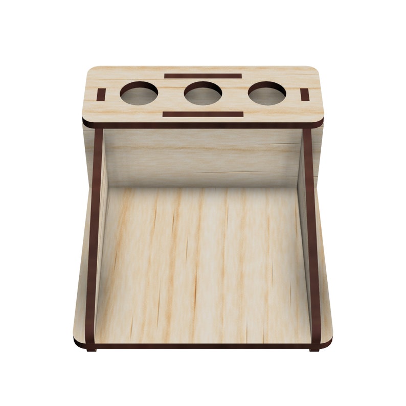 May include: Wooden organizer with three slots for pens or pencils and a larger compartment below. The organizer is made of light wood with a dark brown stain around the edges.