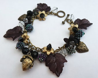 Strawberry charm bracelet, secret message locket, black flowers and leaves, strawberries, blackberries