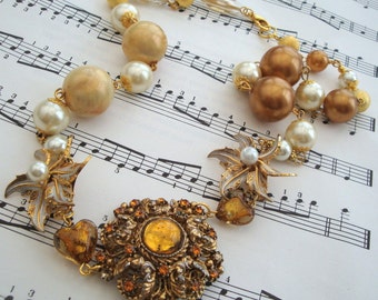 Vintage statement necklace, assemblage, repurposed brooch in topaz coloured glass, with gold and ivory coloured faux pearls