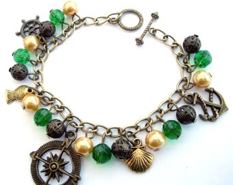 Nautical charm bracelet, pirate sea theme, compass, anchor, shell charms, bronze green gold