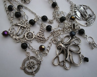 Pirate charm necklace, layered nautical black beads, octopus ship anchor compass silver charms statement