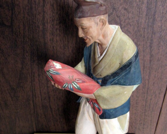 Asian man with baby figure
