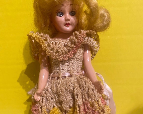 Tiny hard plastic doll