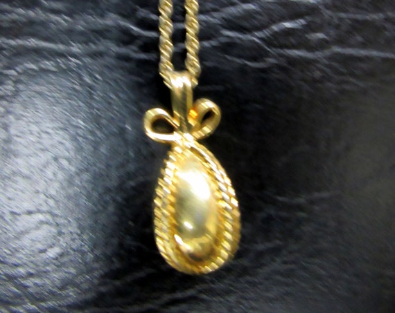 Joan Rivers gold egg pendant necklace