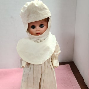 Nun doll in white habit