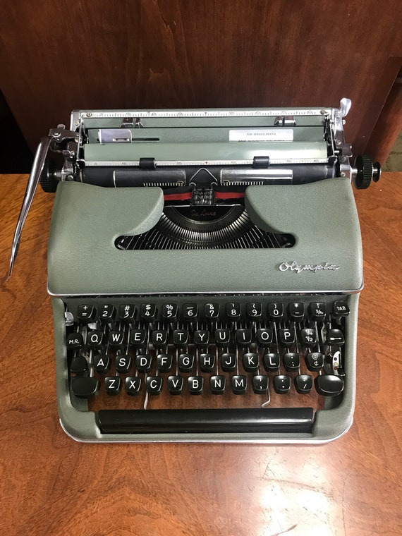 Green Olympia typewriter with metal case