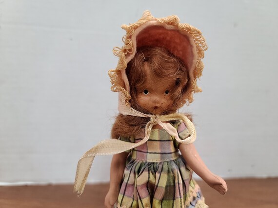 Nancy Ann storybook doll brown hair 5"bisque 1940's in original outfit.