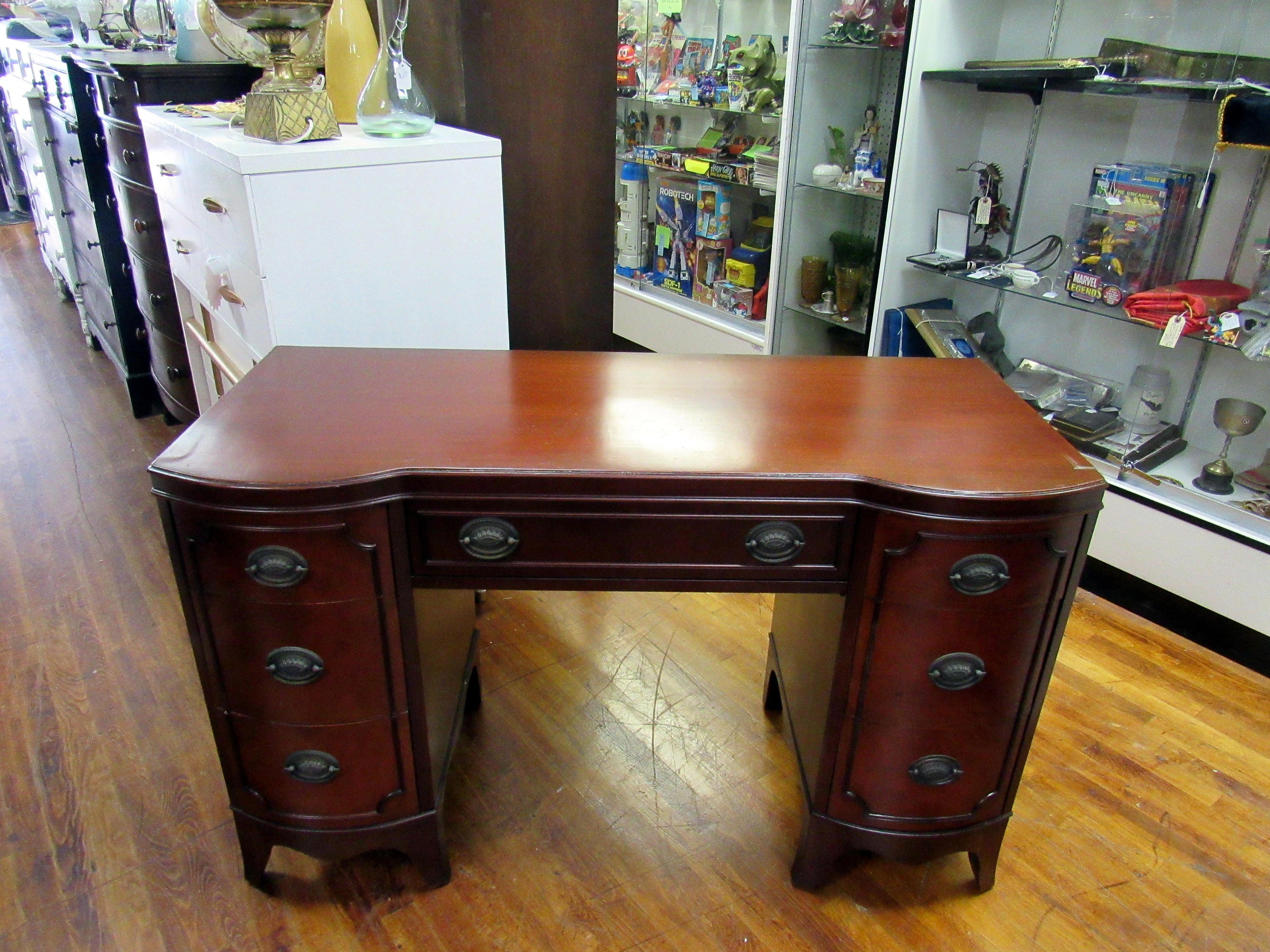 Mahogany Desk with seven drawers and curved front