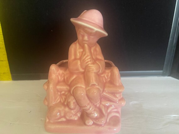 Pink vase or planter boy playing instrument