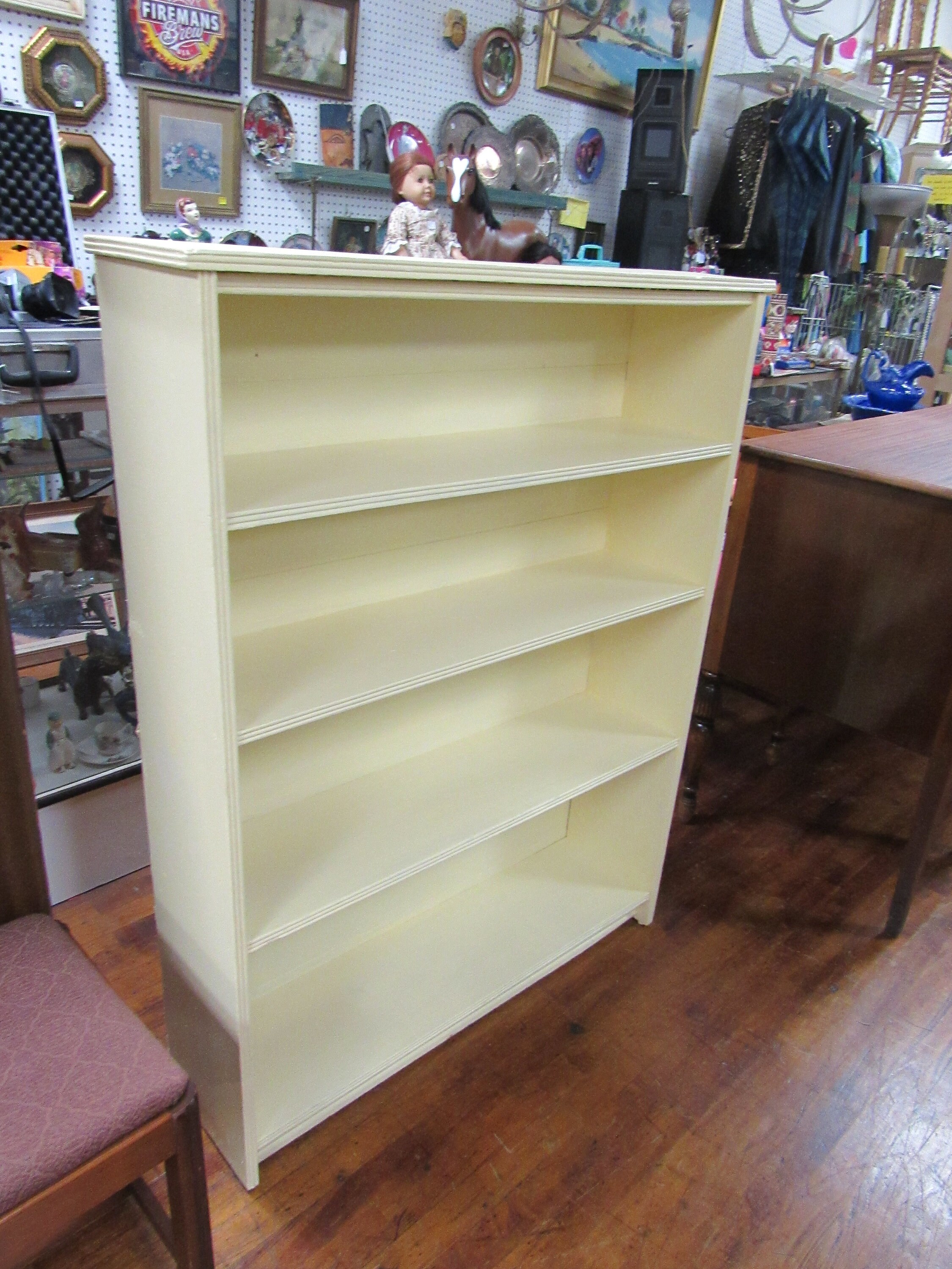Wood bookshelf painted pale yellow