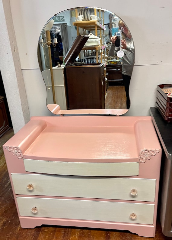 Pink and white dresser with mirror