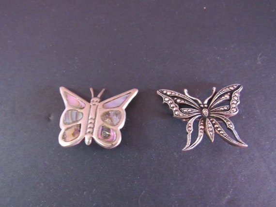 Two butterfly brooches