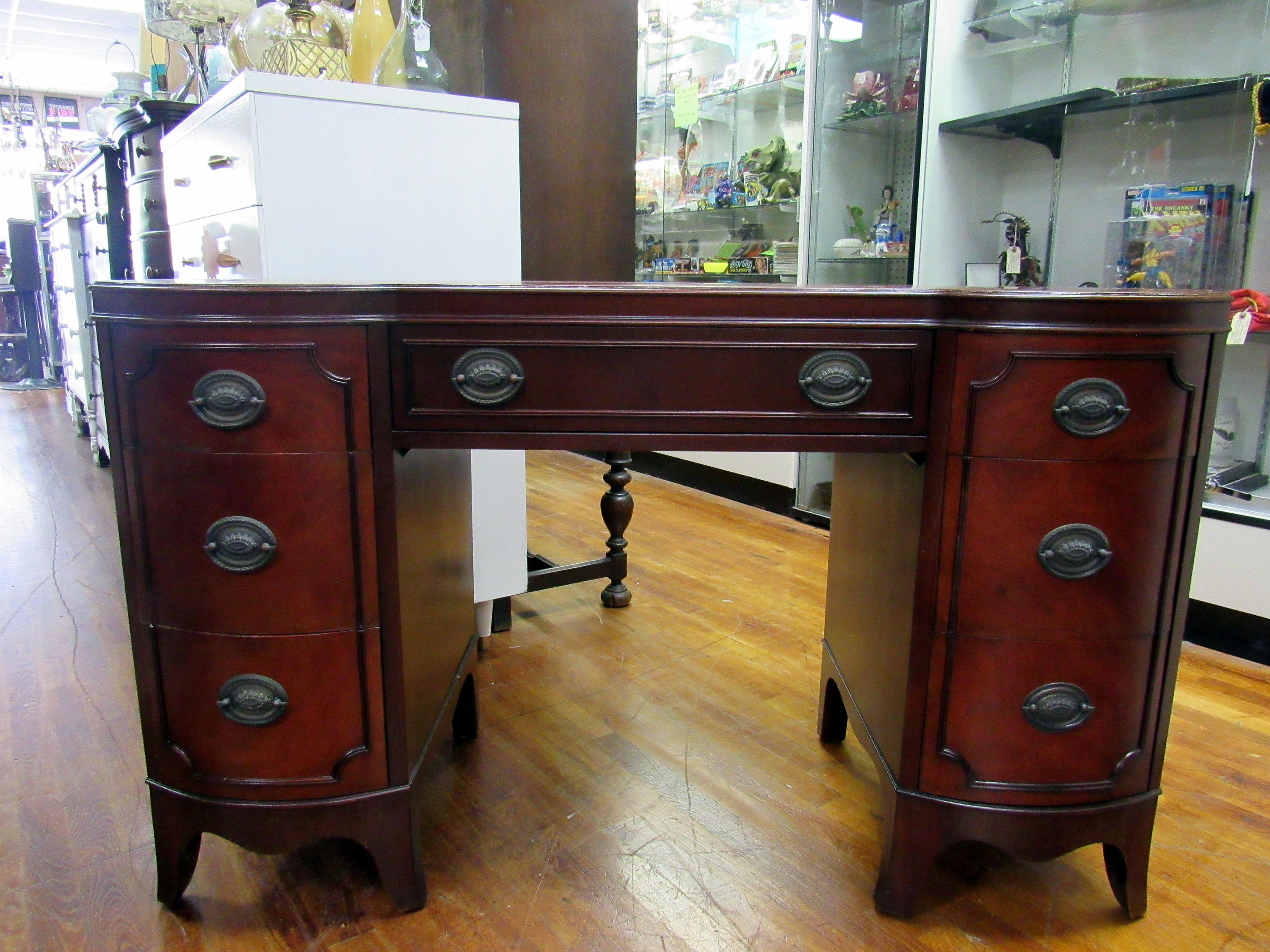Mahogany Desk with seven drawers and curved front