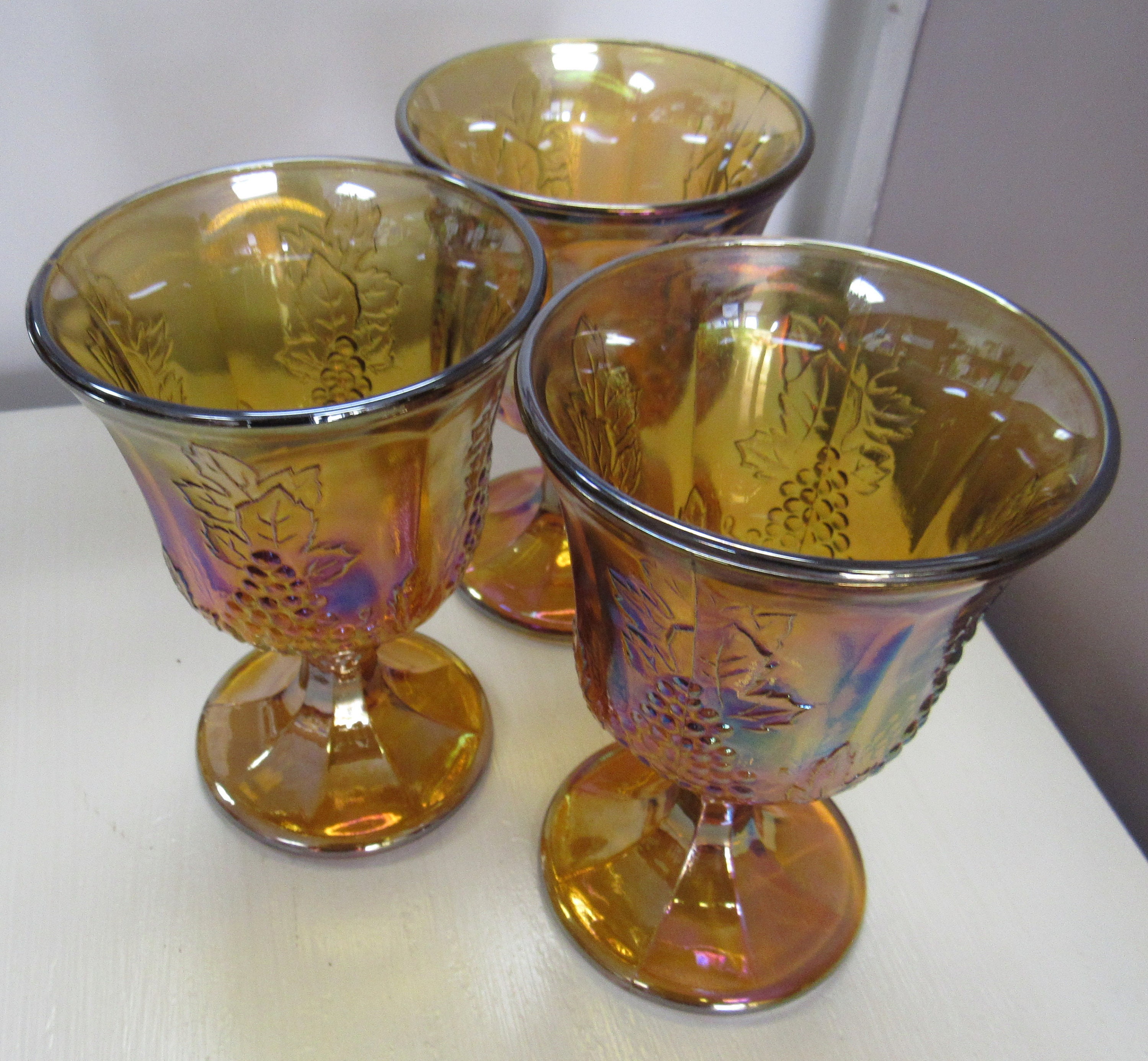 3 amber carnival glass stemmed glasses