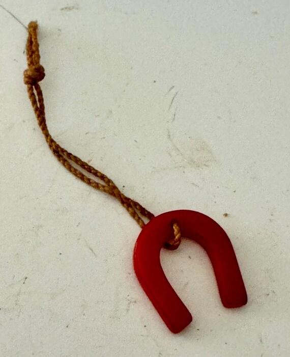 Red Bakelite horseshoe charm