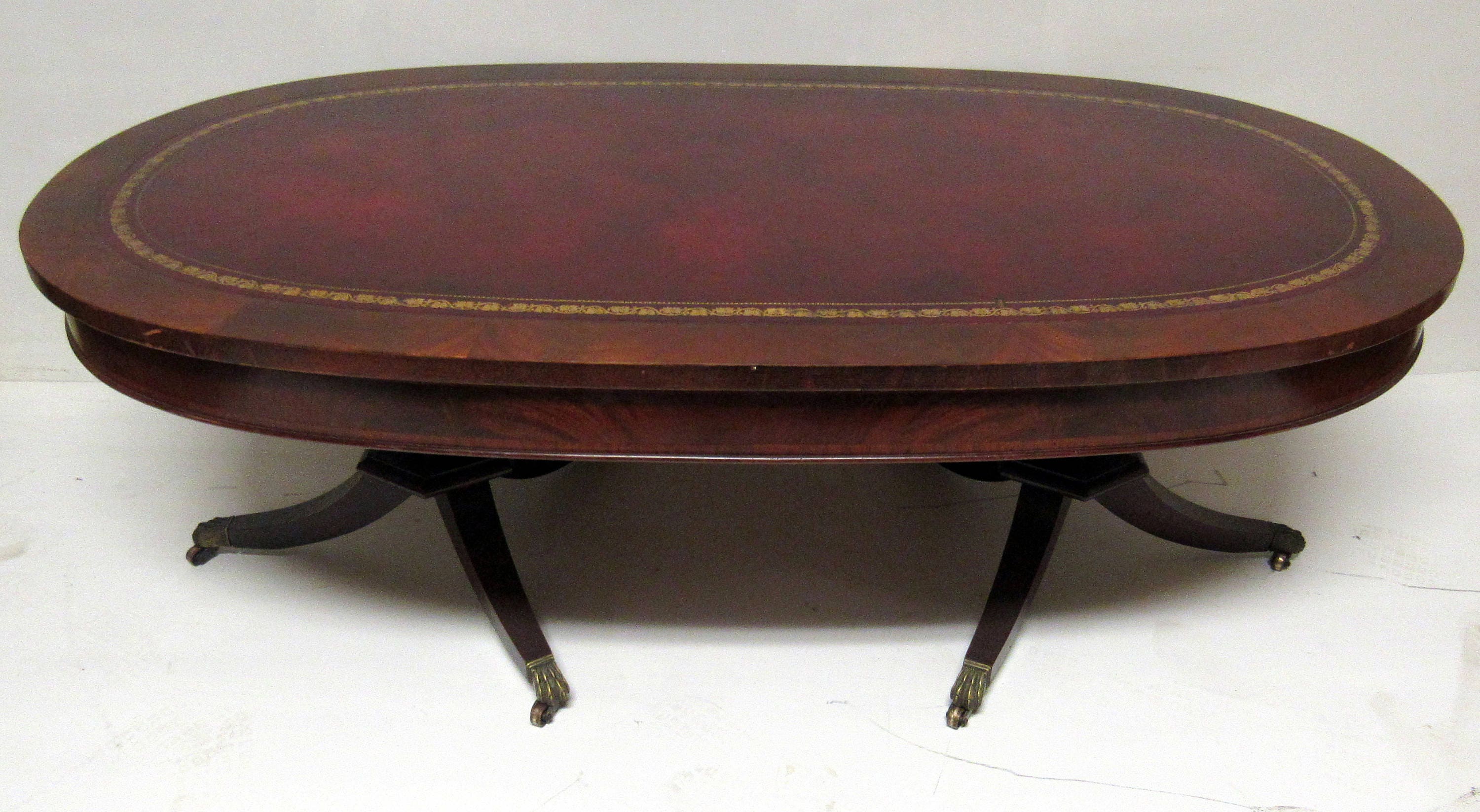 Flame mahogany coffee table oval shaped leather top