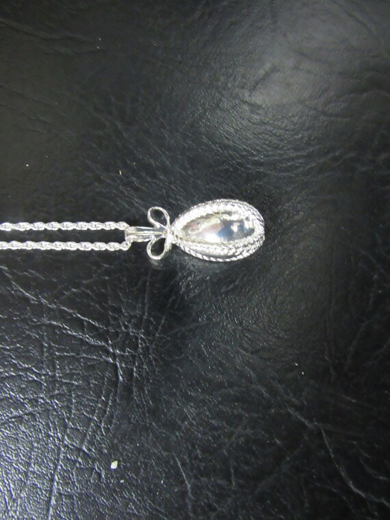 Joan Rivers silver egg pendant necklace