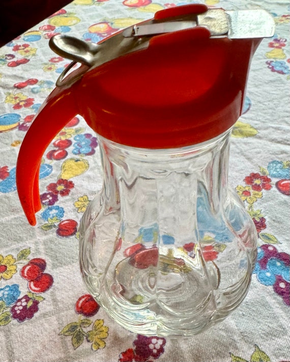 Syrup pitcher with red top