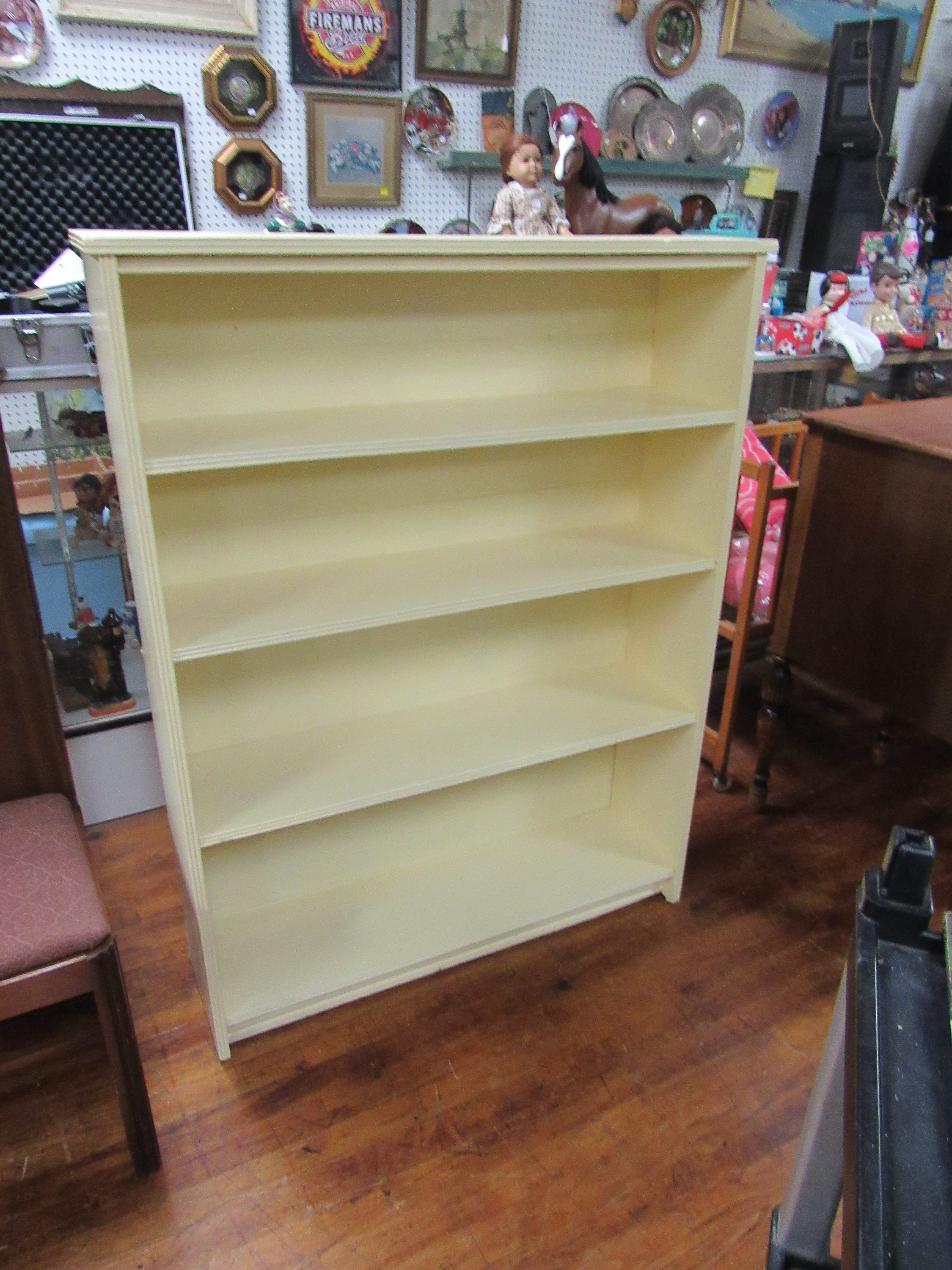 Wood bookshelf painted pale yellow