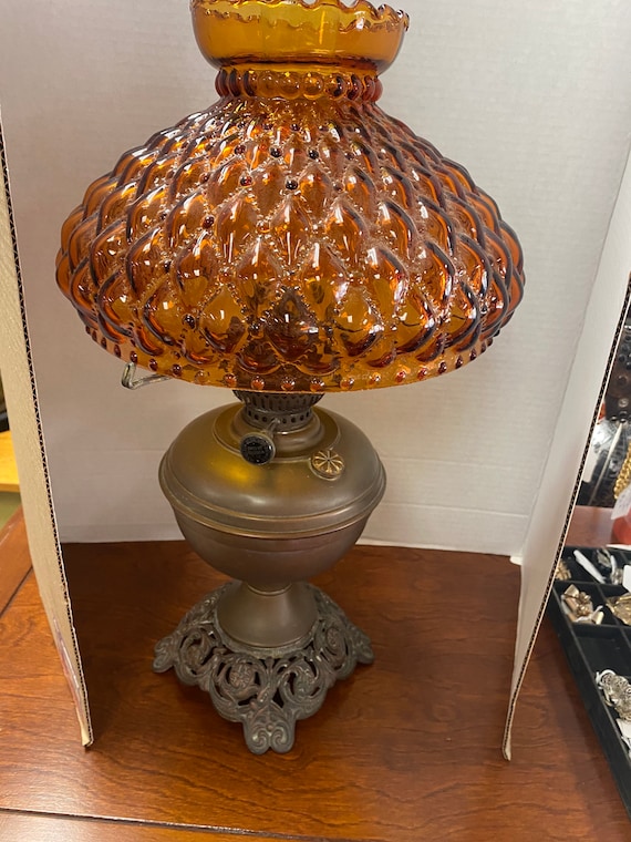 Brass oil lamp with amber glass shade