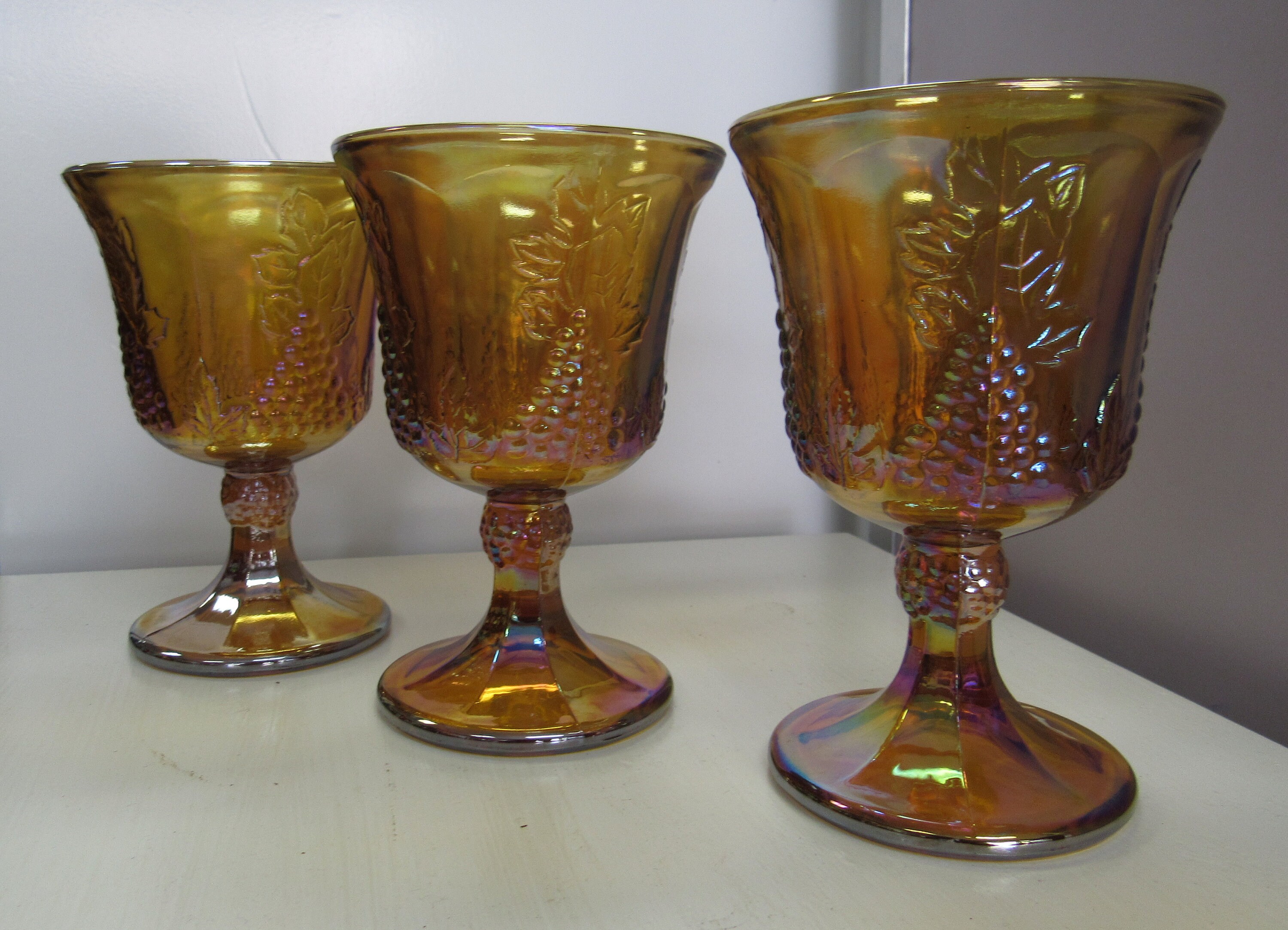 3 amber carnival glass stemmed glasses