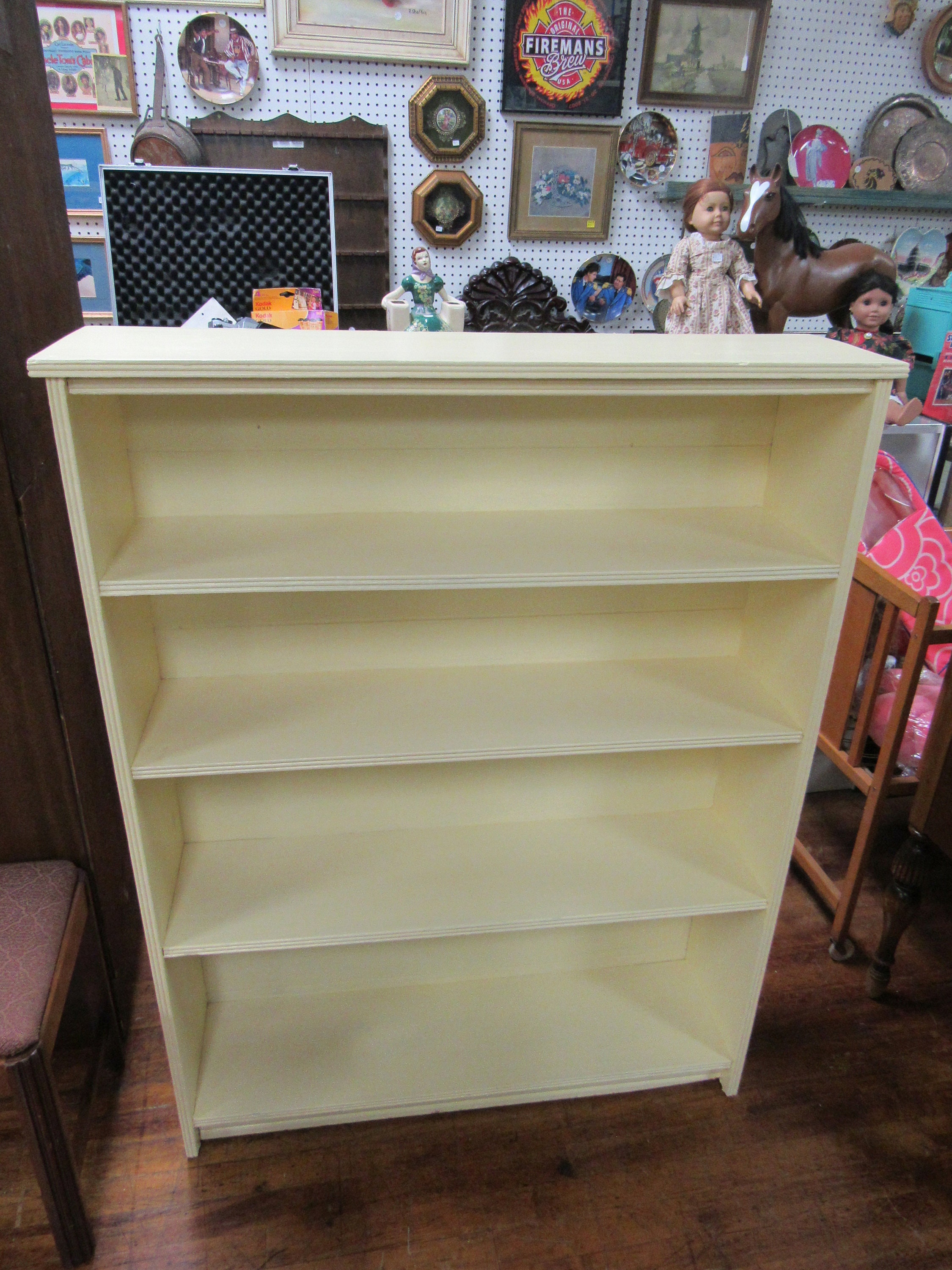 Wood bookshelf painted pale yellow