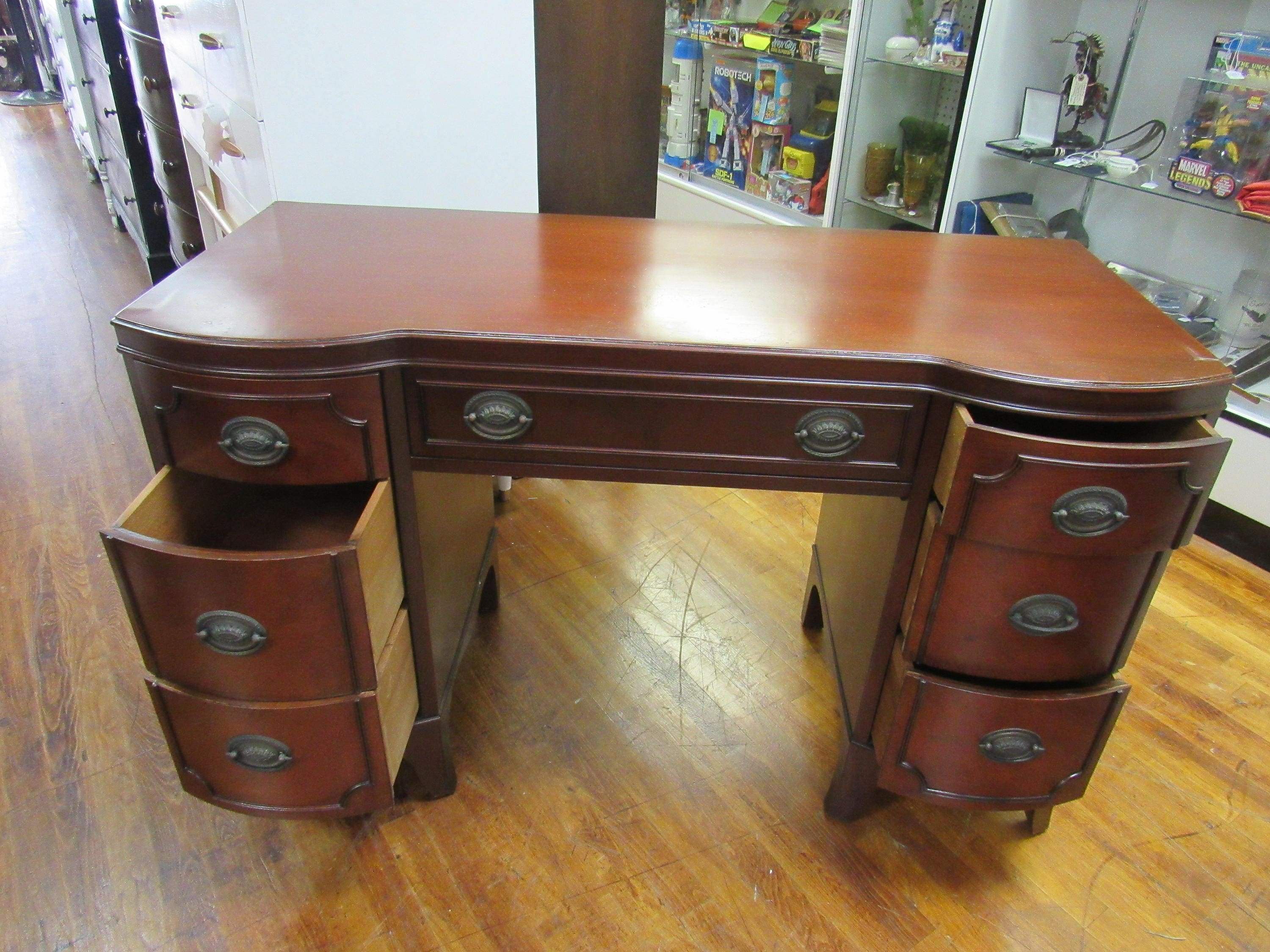Mahogany Desk with seven drawers and curved front