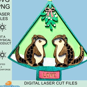 May include: Laser cut file design of two squirrels under a mistletoe decorated Christmas tree with the word "LOVE" on the base. The design is for a wooden ornament.