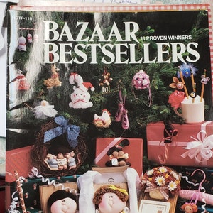 May include: A collection of 18 handmade Christmas ornaments, including a snowman, a reindeer, a stocking, a Santa Claus, a penguin, a teddy bear, a ballerina, a chicken, a mouse, a gingerbread man, a candy cane, a bell, a star, a tree, a wreath, a stocking, a present, and a bow. The ornaments are displayed on a Christmas tree and on a table with presents. The ornaments are made of felt, fabric, and other materials. The ornaments are all different colors and sizes. The ornaments are all handmade and unique.