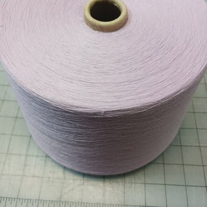 May include: A spool of pale lavender yarn.