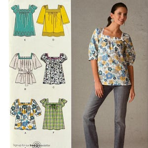 May include: Simplicity sewing pattern 2931 for a square-neck blouse with various sleeve and hem options. The envelope displays technical illustrations of six blouse variations and a photograph of a floral print blouse with three-quarter sleeves.
