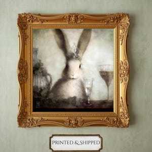 A framed painting of a rabbit wearing a crown, surrounded by wine glasses and a vase, against a light green background.