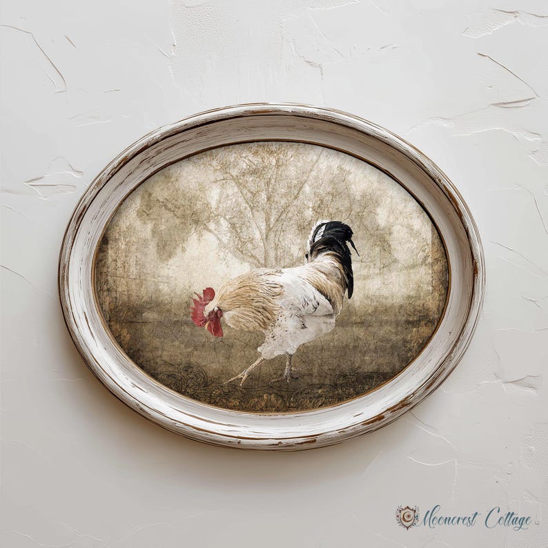 A white oval frame with a picture of a rooster inside it, hanging on a white wall.