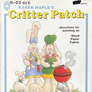May include: A painting kit featuring a family of bunnies with a barbecue and blocks. The kit includes directions for painting on wood, paper, and fabric. The title of the kit is "Critter Patch" by Karen Maple's.