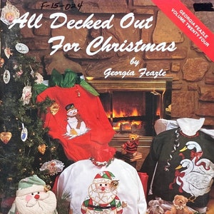 May include: A book titled "All Decked Out For Christmas" by Georgia Feazle. The book cover features a fireplace with a Christmas tree and various Christmas-themed decorations, including a snowman, Santa Claus, and swans.