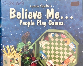 May include: A collection of painted wooden game pieces and decorative boxes. The image features a checkerboard tray, dominoes, and a box with a sun and watermelon design. The text "Believe Me... People Play Games" is visible.