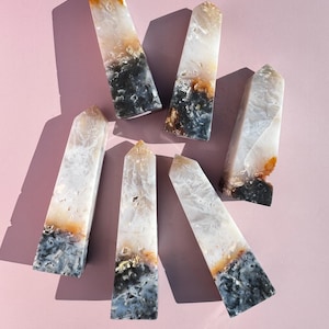 May include: A set of three ceramic mugs with a speckled, matte finish. The mugs are in shades of cream, light grey, and dark grey. Each mug has a simple, minimalist design, ideal for coffee or tea.