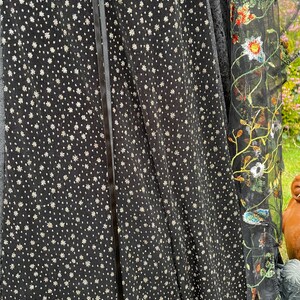 May include: Black sheer fabric with a silver glitter pattern and a black satin ribbon down the center.