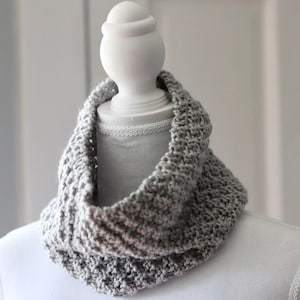 gray knitted seed stitch cowl scarf on a white linen mannequin