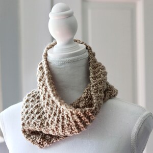 beige knitted seed stitch cowl scarf on a white linen mannequin