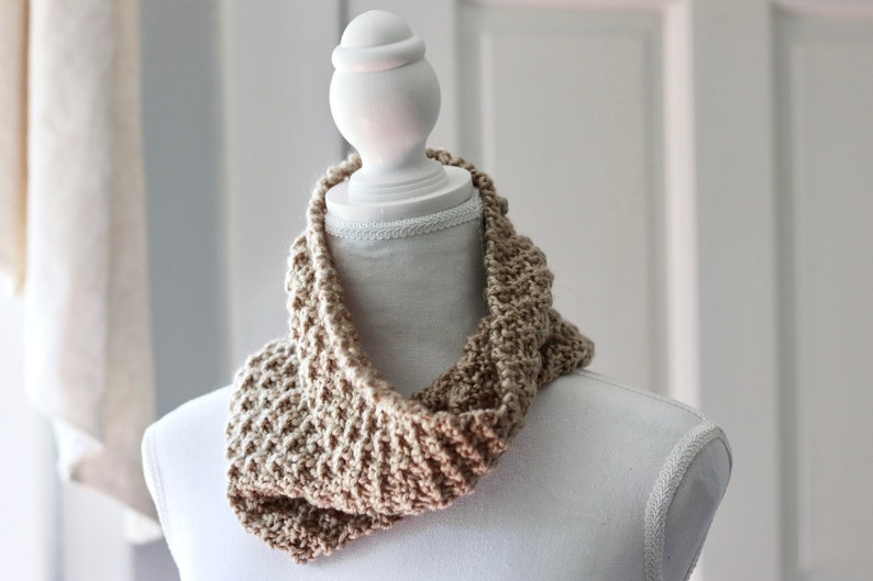 beige knitted seed stitch cowl scarf on a white linen mannequin