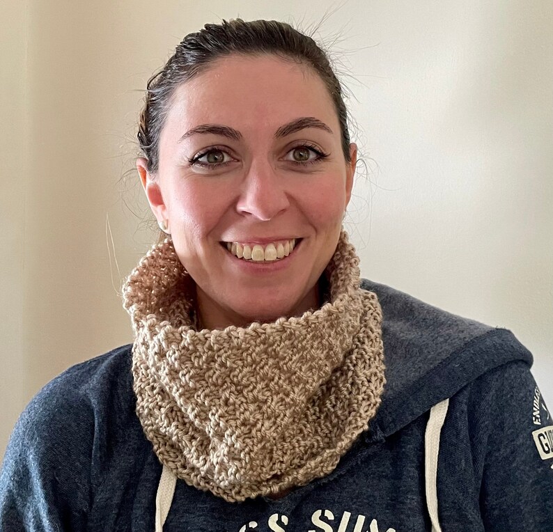 beige knitted seed stitch cowl scarf on a smiling woman
