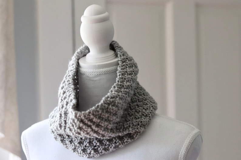 gray knitted seed stitch cowl scarf on a white linen mannequin