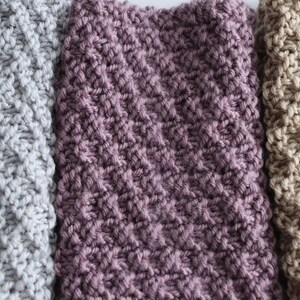 gray, purple, and beige knitted seed stitch cowl scarfs next to one another