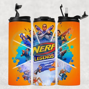 May include: Orange tumbler featuring the "NERF Legends" logo and action-packed graphics of characters with toy blasters. The tumbler has a black lid with a straw and a flip-top closure. The design includes blue, orange, and yellow accents.