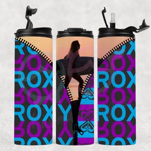 May include: A white ceramic mug with a black handle and the text "But First, Coffee" in a bold, black font. The mug is set against a blurred background, suggesting a cozy setting.