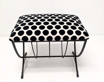 May include: A black and white polka dot upholstered ottoman with a metal frame.