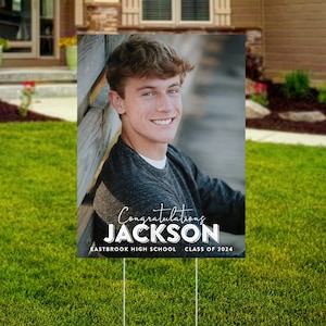 May include: A graduation yard sign with a photo of a young man, the text "Congratulations Jackson", "Eastbrook High School", and "Class of 2024".