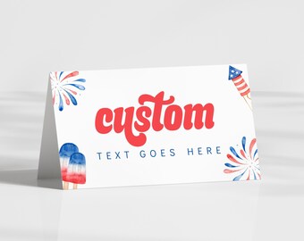 May include: A white card with the word "custom" in red script. The card is decorated with watercolor illustrations of fireworks, a rocket, and popsicles in red, white, and blue. The text "TEXT GOES HERE" is below the word "custom".