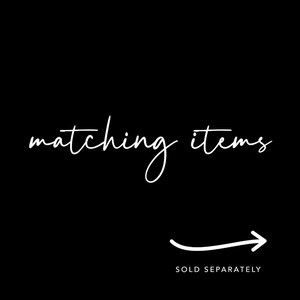 May include: Matching items, white text on a black background. The text is written in a cursive font. An arrow pointing to the right is below the text. The text "SOLD SEPARATELY" is below the arrow.